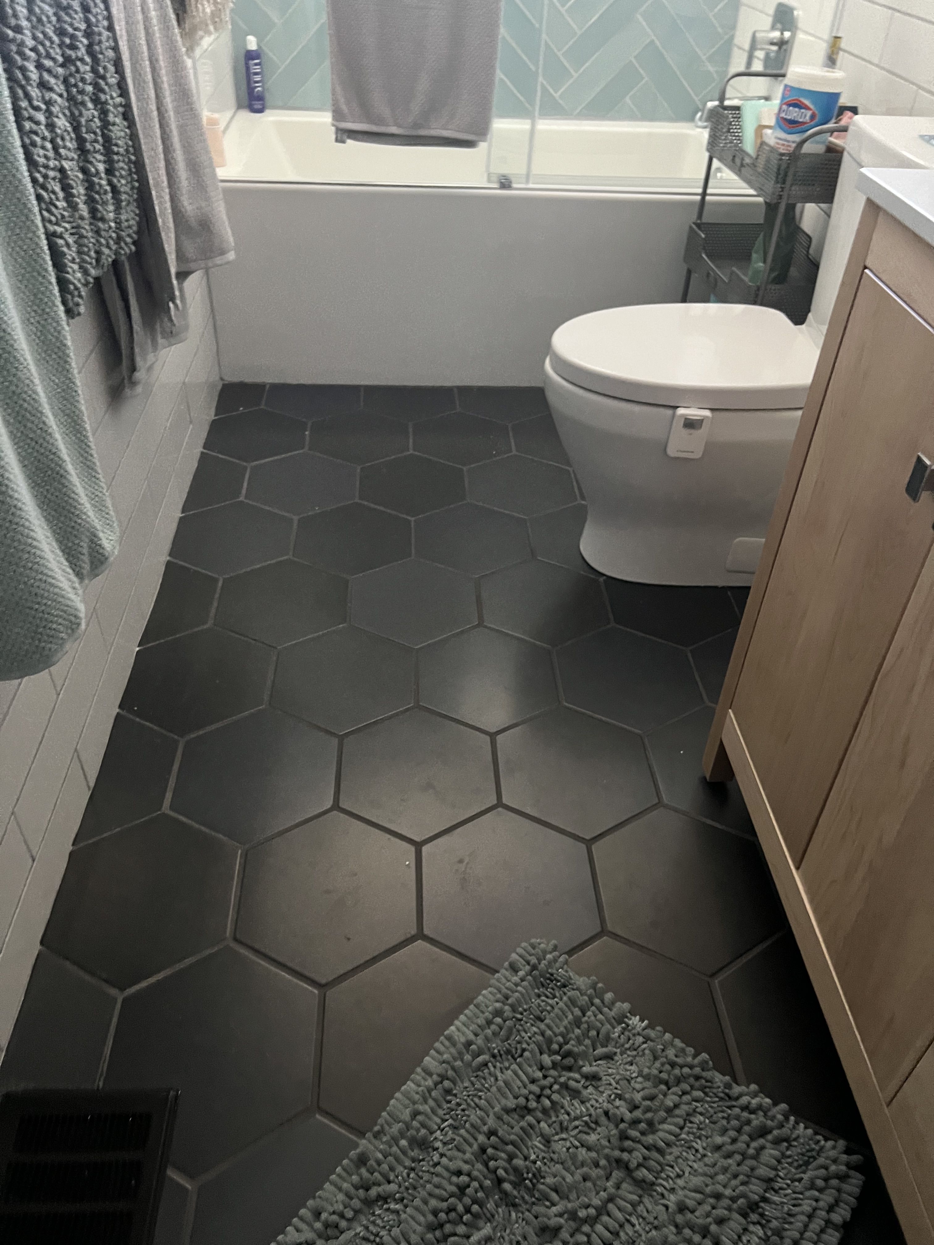 15 Black Hexagon Tile Bathroom Floor Ideas With Bold Pattern - 13. Black Hexagons with Stone Accents 1